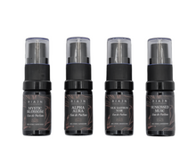 Four black perfume bottles with labels on a white background. RIAJN eau de parfum sample set.