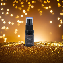 RIAJN Chateau Luxe Diffuser Scent bottle on a mount of gold dust with glowing small circles in the background. Long lasting reed diffuser.