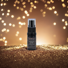 Black spray bottle labeled  RIAJN Chateau Luxe on a glittery surface with blurred lights in the background. Best fresh and long-lasting home fragrance aroma.