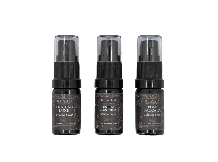 Three Riaan brand diffuser spray bottles on a white background
