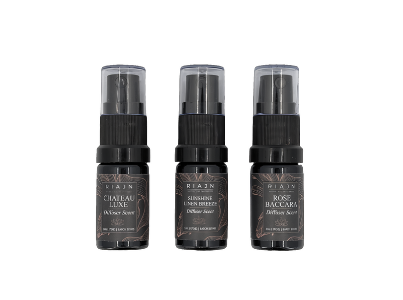 Three Riaan brand diffuser spray bottles on a white background