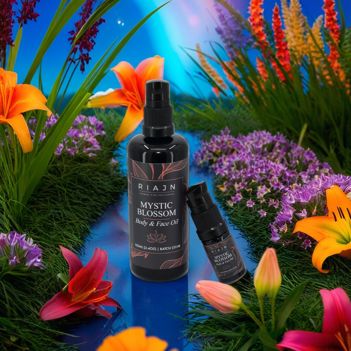 RIAJN Mystic Blossom Face Oil bottles on top of blue water surrounded by colorful flowers in grass and blurry rainbow in the background. Popular body oil and face oil to rejuvenate your skin.