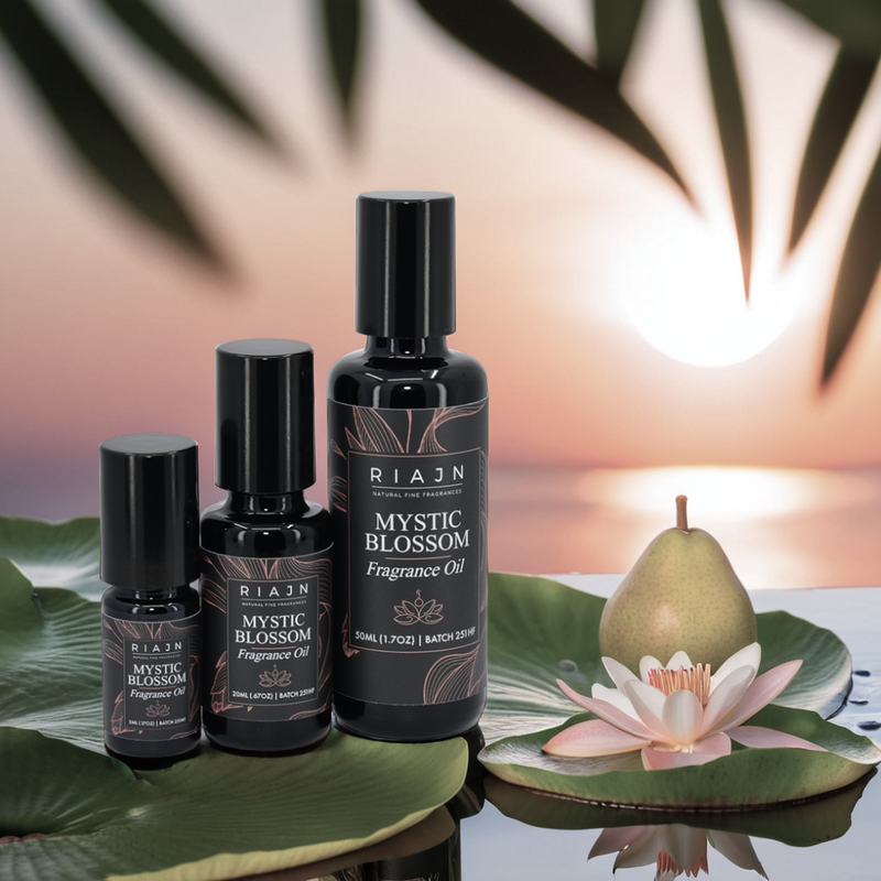 Rian Mystic Blossom perfume oil bottles with a sunsetting background featuring a pear and flower.