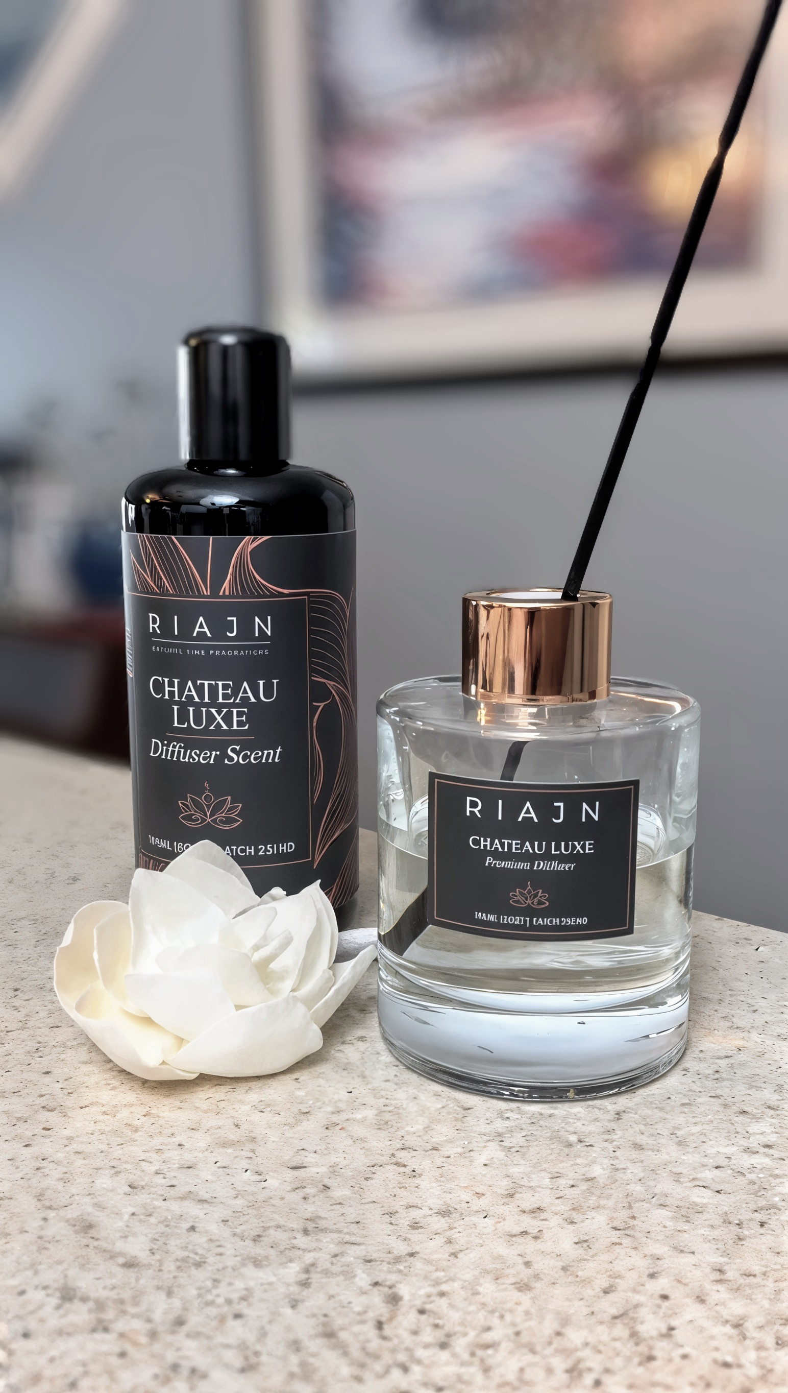 RIAJN Chateau Luxe diffuser and bottle on a surface with a blurred background on a counter in a home setting.