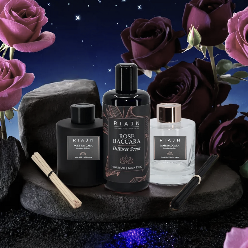 Three RIAN Rose Baccara diffuser home fragrance bottles on a dark surface with roses in the background