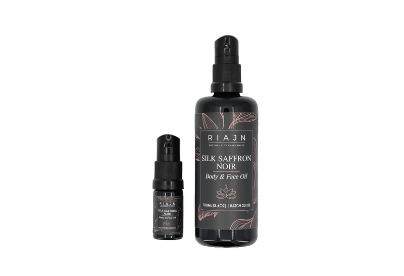 Two bottles of RIAHN Silk Saffron Noir body and face serum on a white background