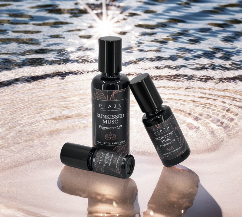 Riajin Sunkissed Musc fragrance oil bottles on a reflective surface with water in the background