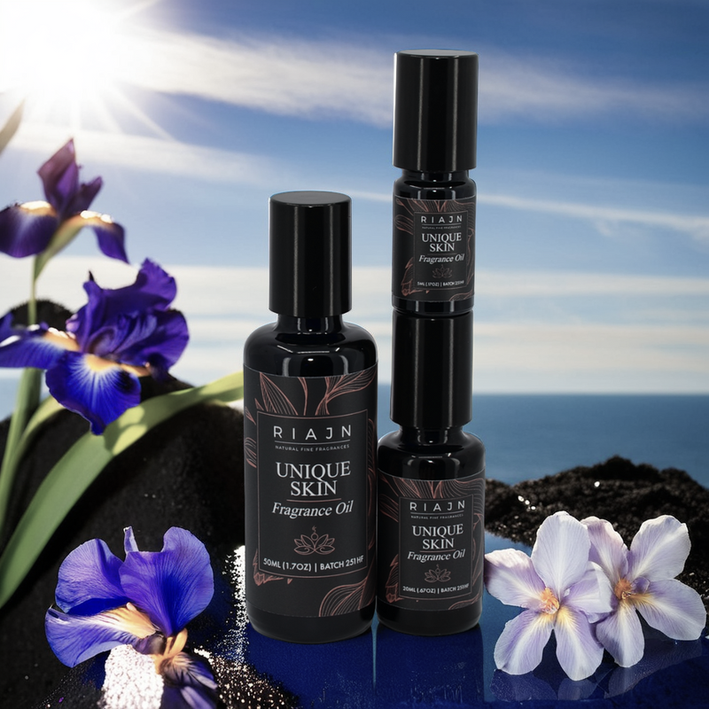 Two bottles of RIAUN Unique Skin Fragrance Oil with flowers and a scenic background